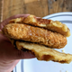 hand holding chik'n and waffle sandwich